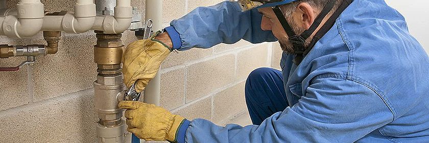 image of plumber with a wrench